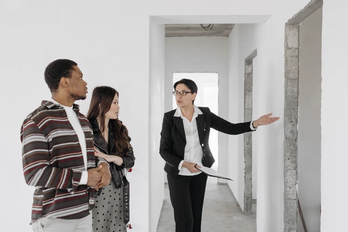 Real estate agent showing a property to prospective buyers