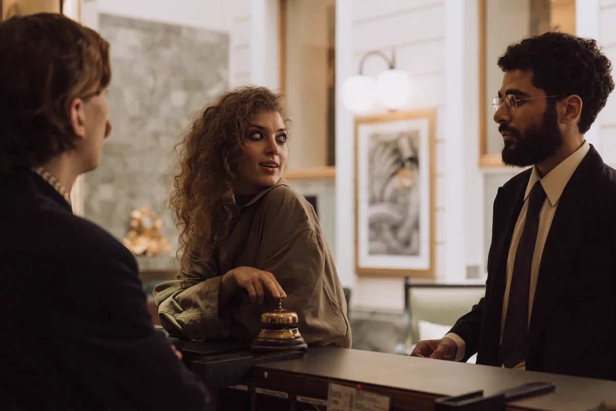 Hotel guests checking in with concierge staff at the front desk