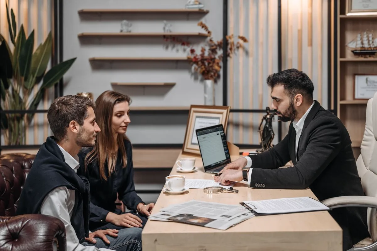 Loan officer reviewing a small-business loan application with the applicant