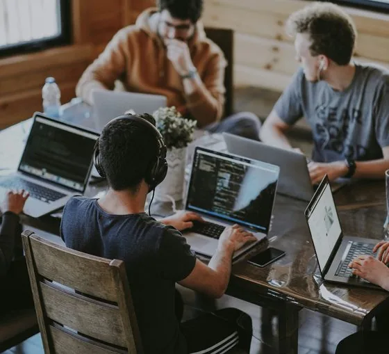 Group of coworkers using a laptop together