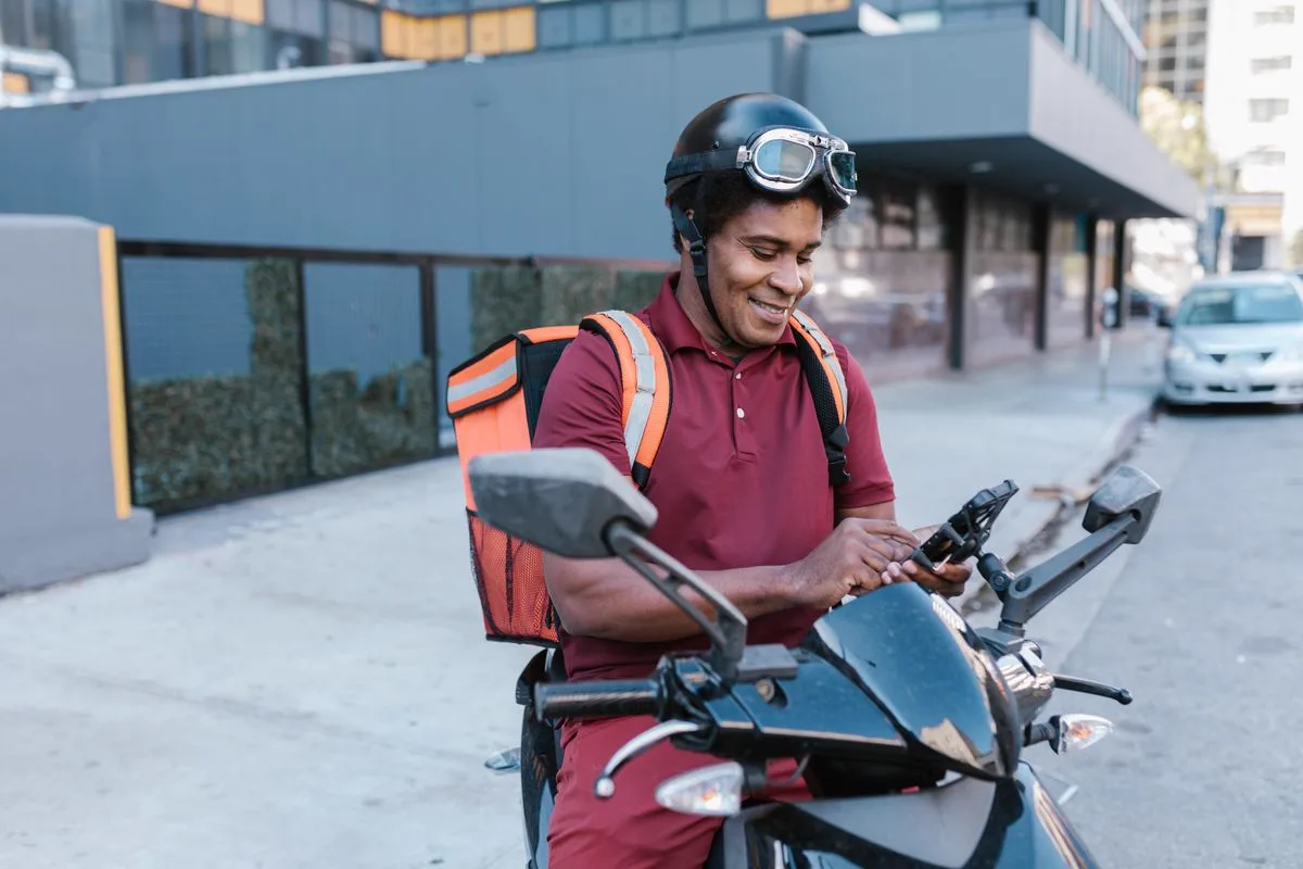 Delivery rider checking a route on a mobile app
